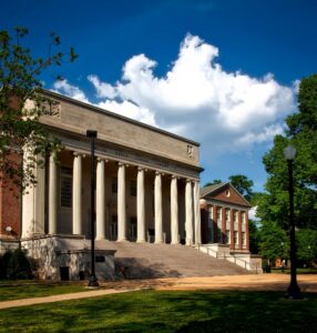 Historic neoclassical university library with columns on a sunny day.